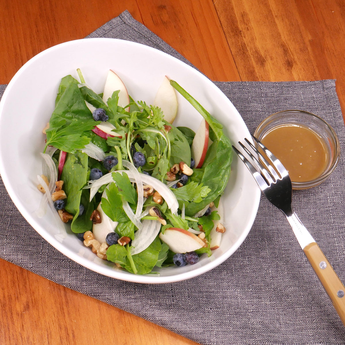 Arugula and spinach salad with apples, wild blueberries and walnuts / Maple balsamic vinaigrette
